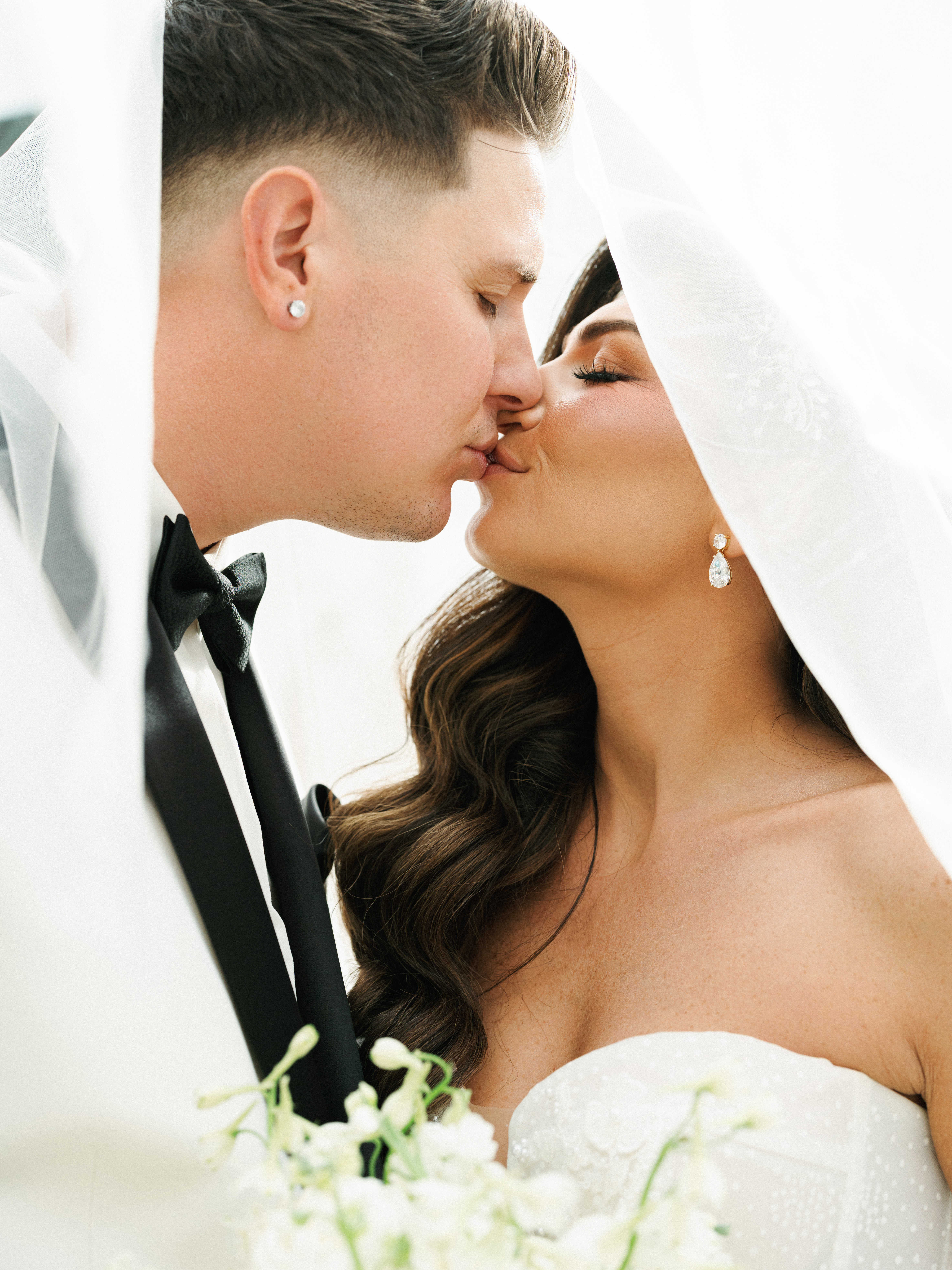 Timeless destination wedding couple moment under a flowing veil highlighting premium wedding photographer contract deliverables