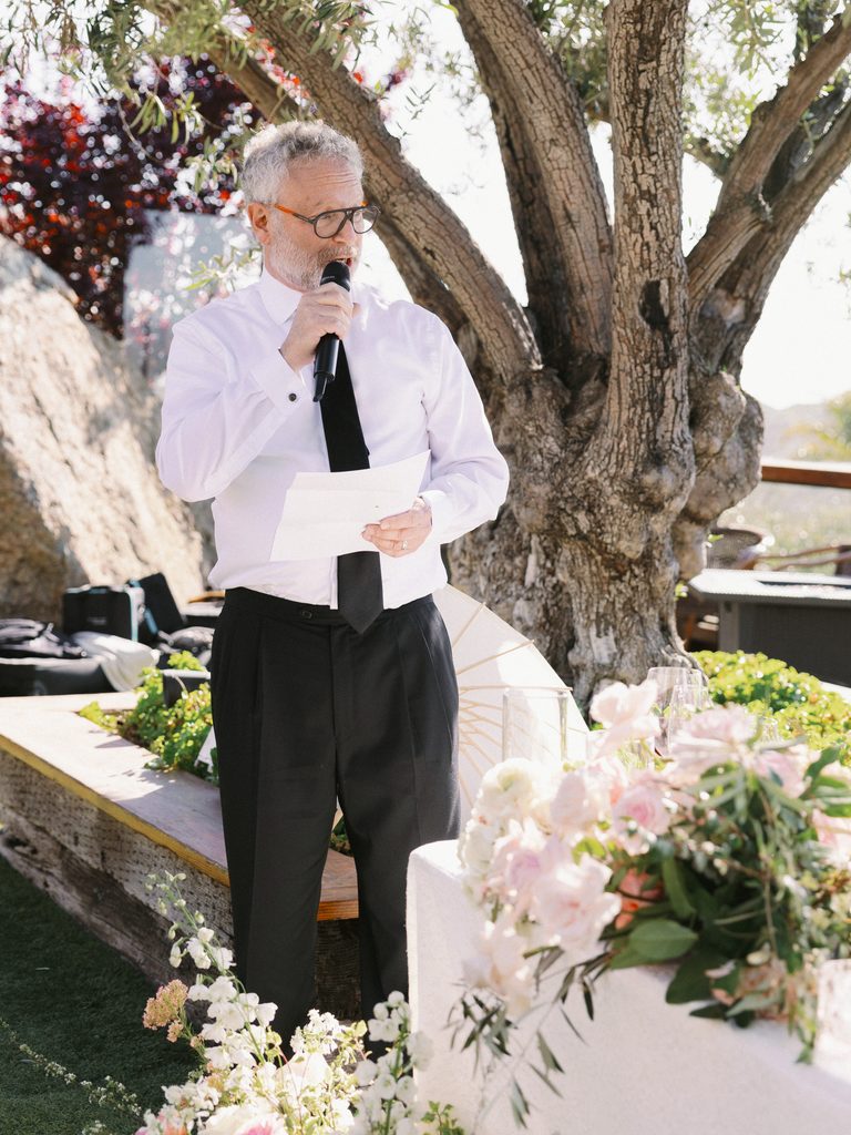 Candid reception speech moment illustrating the journalistic coverage of a wedding photo gallery.