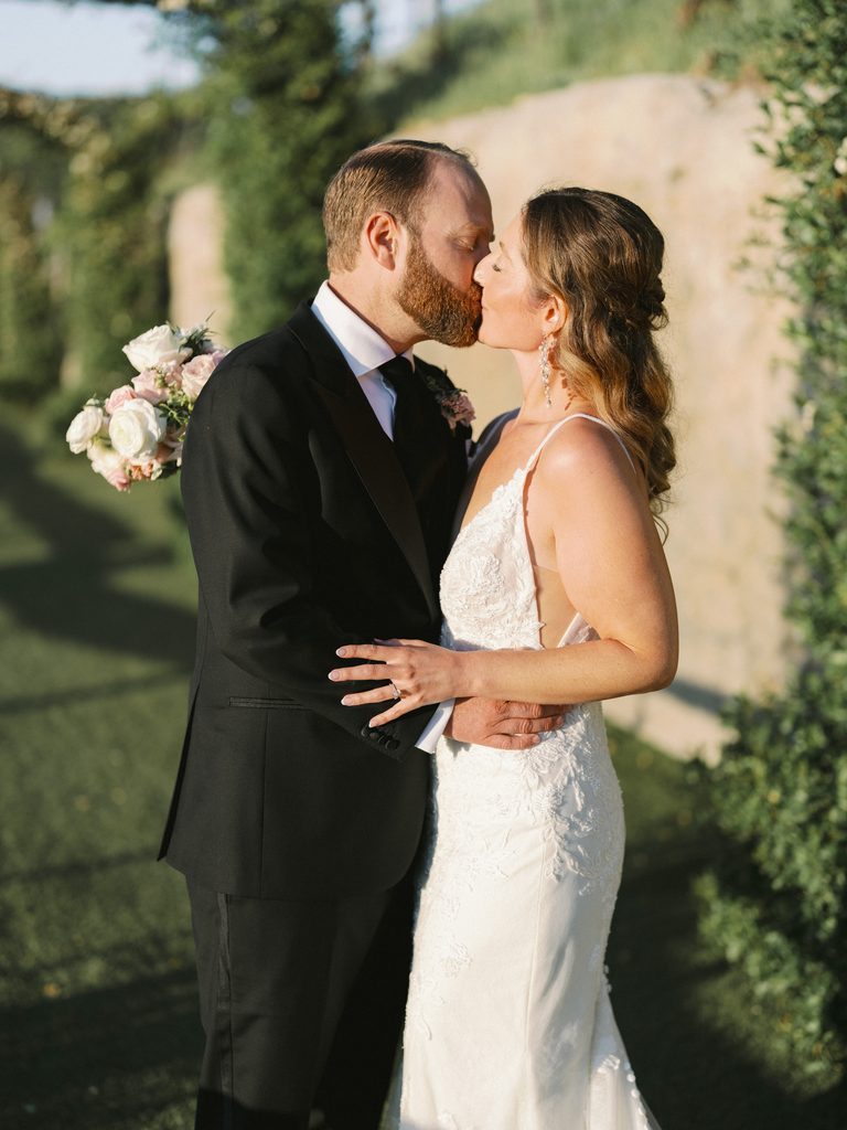 Intimate golden hour kiss highlighting romantic portraiture in a luxury wedding photo gallery.