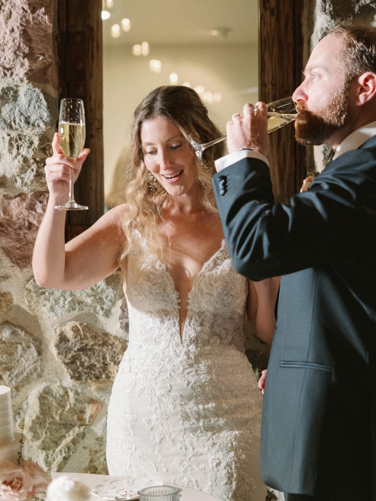 Candid champagne toast moment illustrating the reception highlights of a wedding photo gallery. 