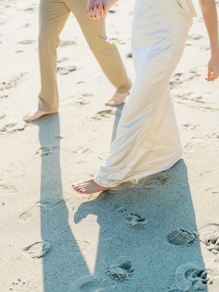 Cropped details of flowing fabrics, perfect for beach-inspired engagement photo outfits.
