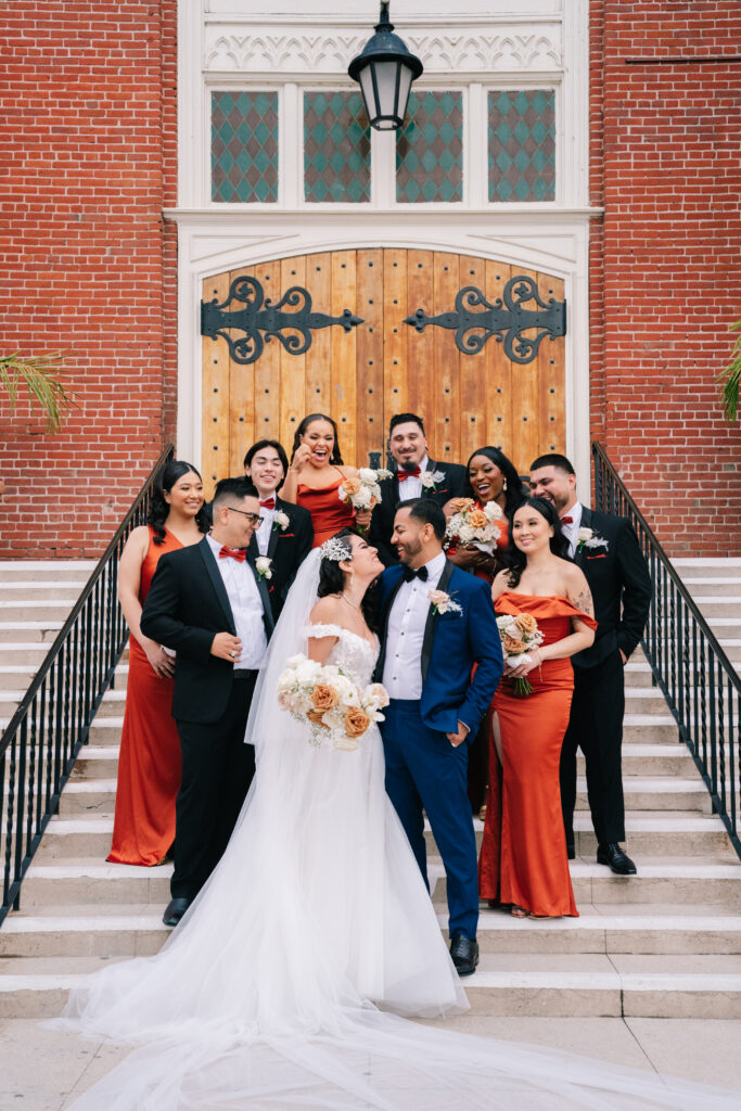A bride and groom on their wedding day, showcasing the intricate lace details of her gown and long veil. This beautiful moment was part of a celebration expertly managed by wedding planning expert Jess Valenzuela. Dreamwood Photo.