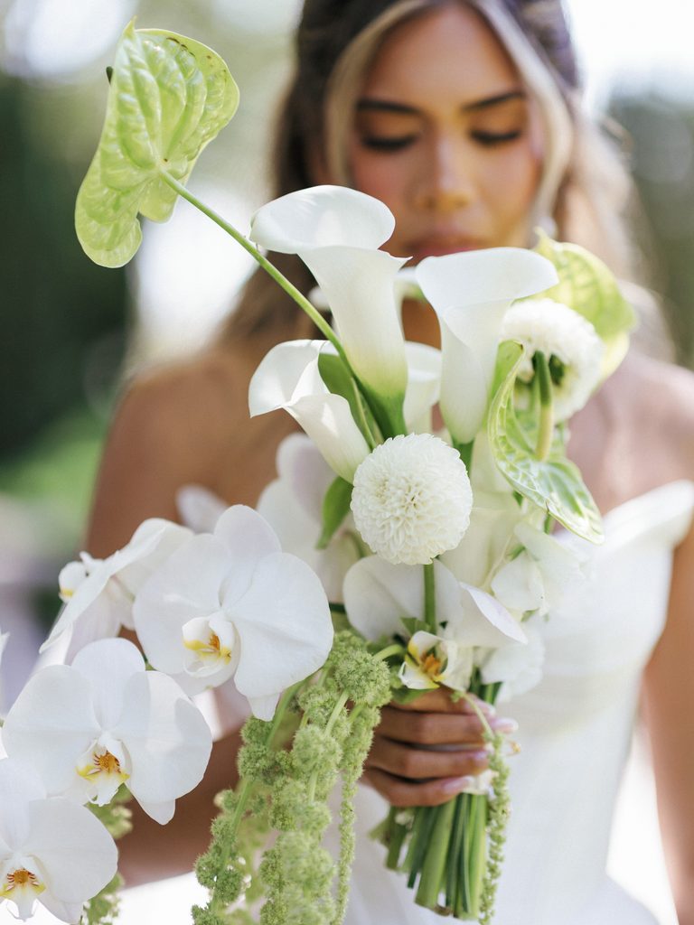 Close up wedding bouquet with white phalaenopsis orchids calla lilies and green anthurium flowers