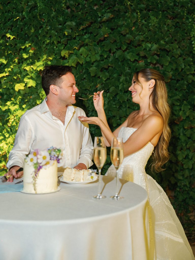 Romantic couple cutting cake luxury California vineyard reception ideas inspiration