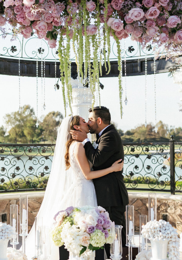 Spectacular persian wedding ceremony altar setup featuring mirrored table with lavish floral arrangements