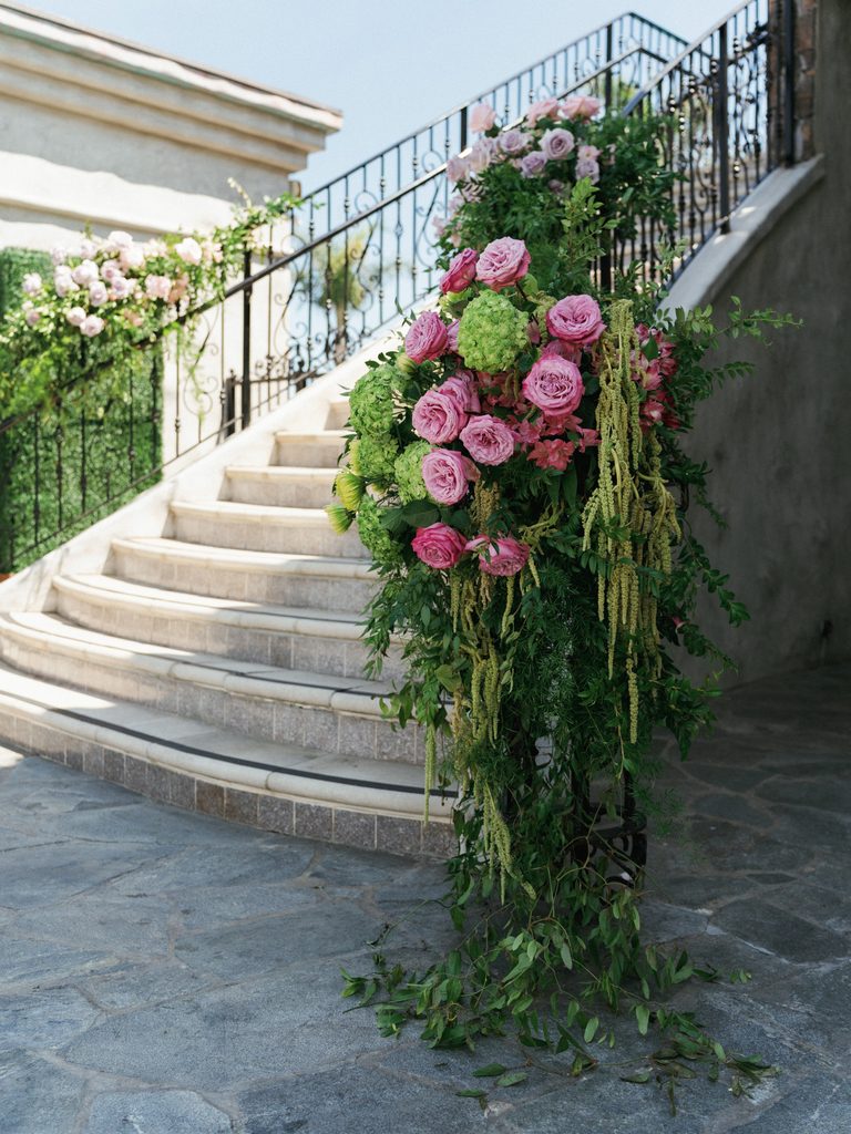 Sophisticated courtyard scenery with spectacular rose floral designs along classic stone pathway steps