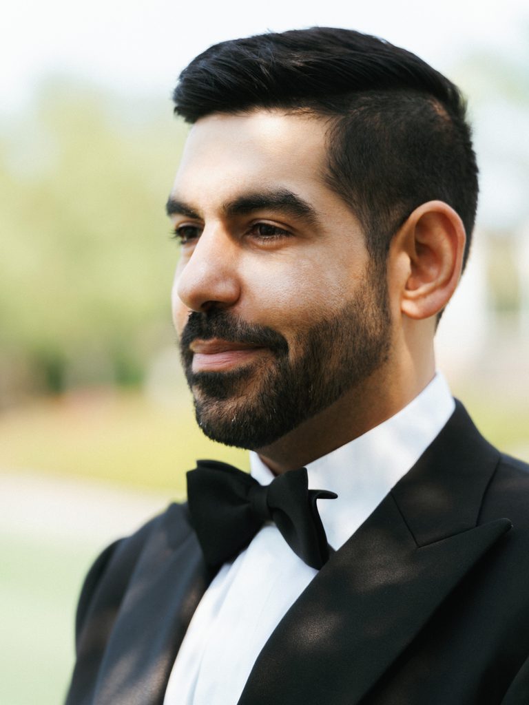 Sophisticated black tie groom close up highlighting neat beard and elegant styling