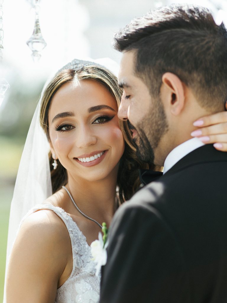 Close up of happy asian bride leaning against her husband chest with deep emotional smile