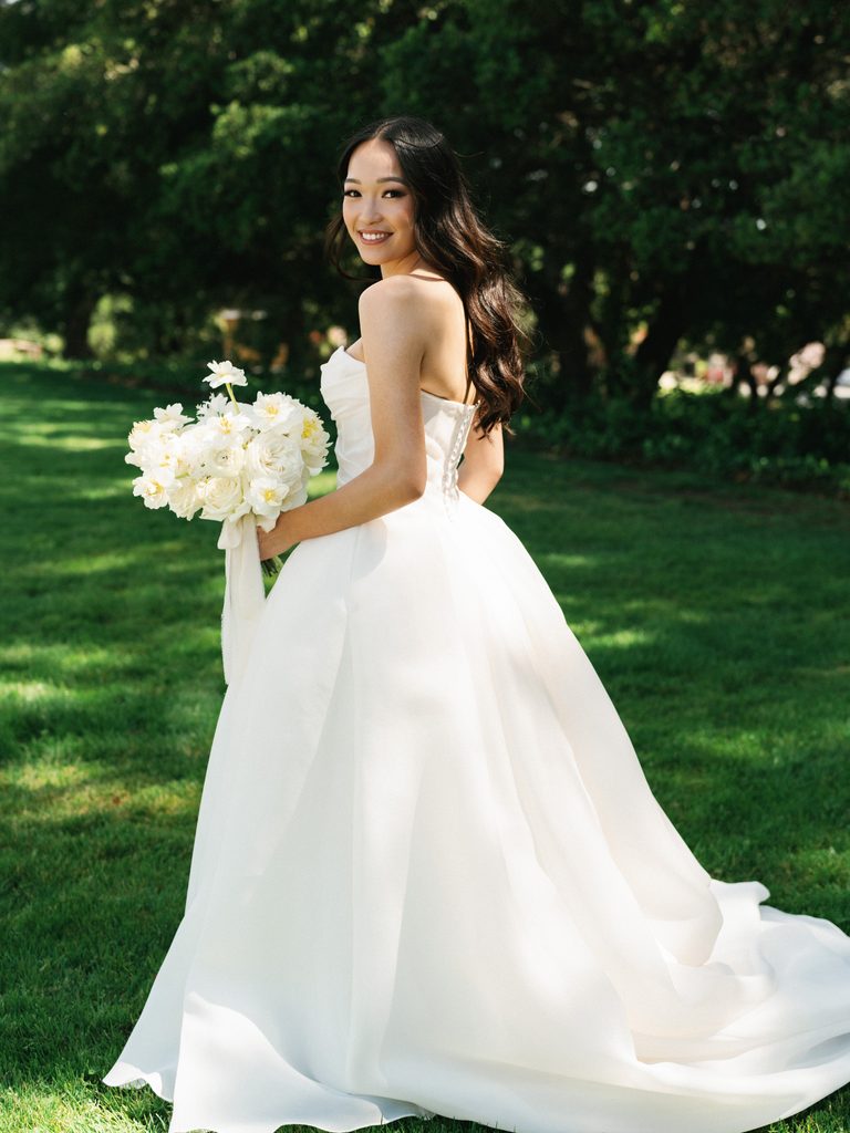 Elegant wedding dress back view showing classic bridal gown buttons and long silk train