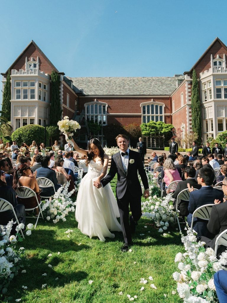 Joyful newlyweds walking down aisle during sunny kohl mansion wedding ceremony coverage