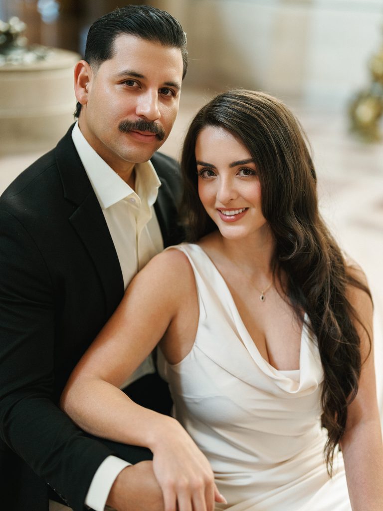 Elegant bride and groom sitting on stairs during California winter city hall wedding