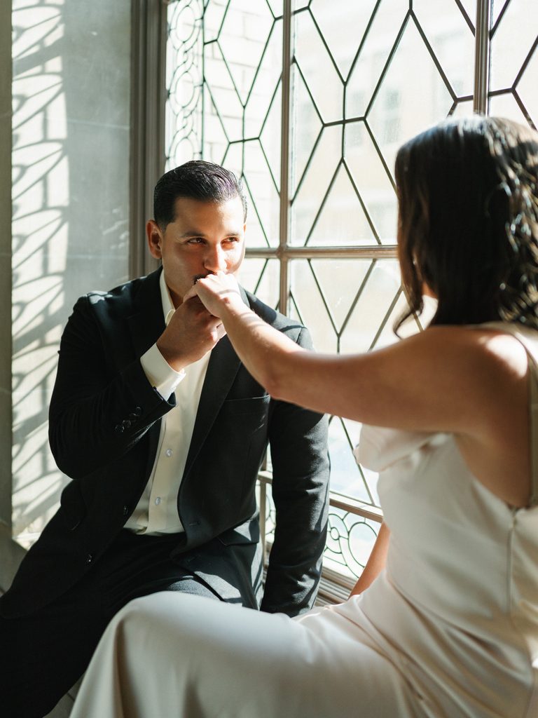 Romantic winter wedding couple portraits indoor with beautiful window light reflection