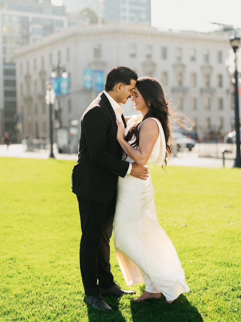 Elegant bride and groom posing on lawn romantic winter elopement photography inspiration