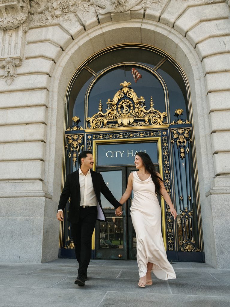 Candid bride and groom running outdoor during luxury San Francisco winter wedding photoshoot
