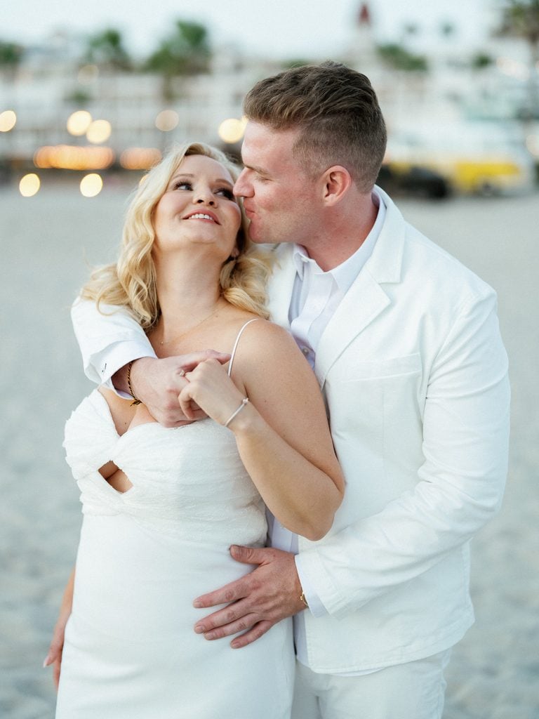 Romantic newlyweds looking at each other for elegant beach blue hour wedding photos
